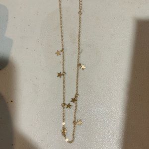 Gold colored star necklace in box NWOT